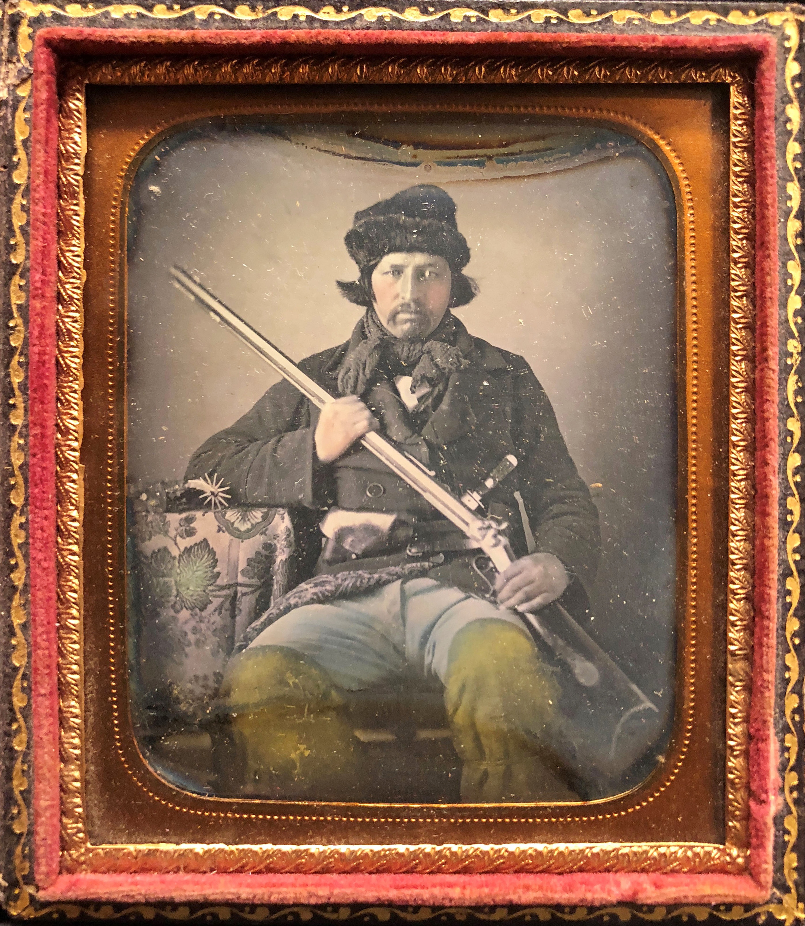 Historical colorized portrait of Isaac Brown in ornate red frame