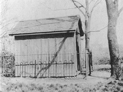 Black and white photo of Fort Conley, a small wooden building, erected by the Conley Sisters