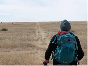 A person backpacking through the prairie