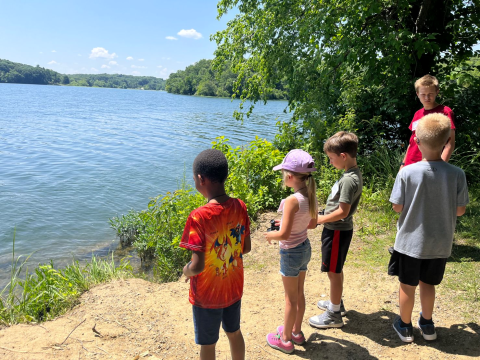 Students with binoculars staring out to Wyco Lake