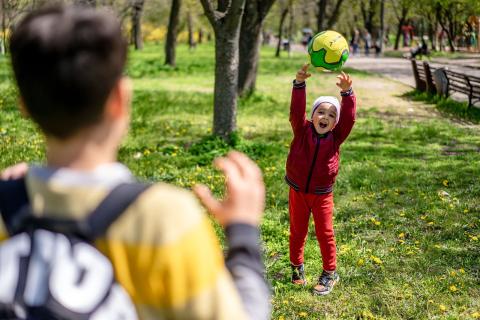 Children throwing a soccer ball back and forth