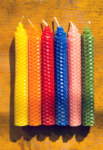 colorful candles on a wood background