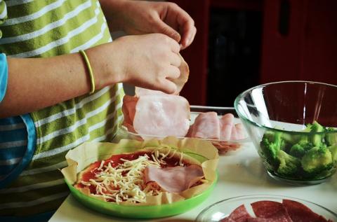 Kid's hands preparing food