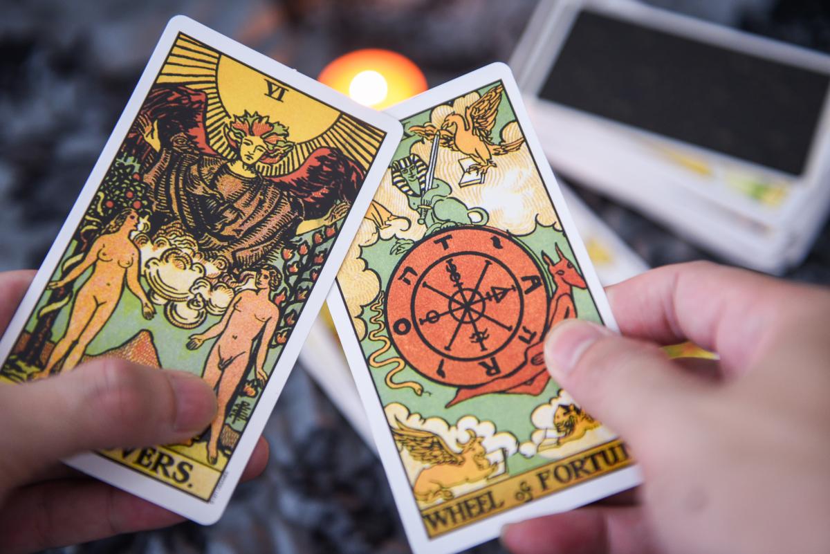 hands holding tarot cards