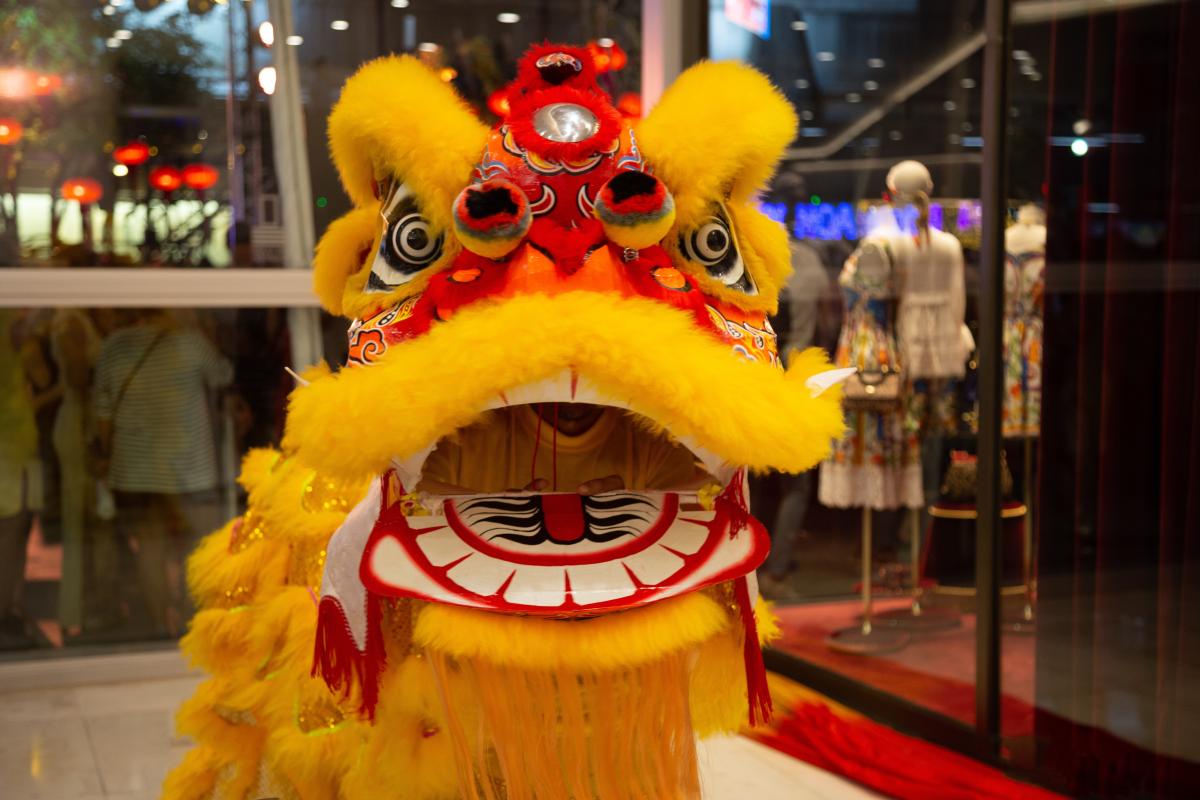 performer in yellow traditional Chinese lion dance costume