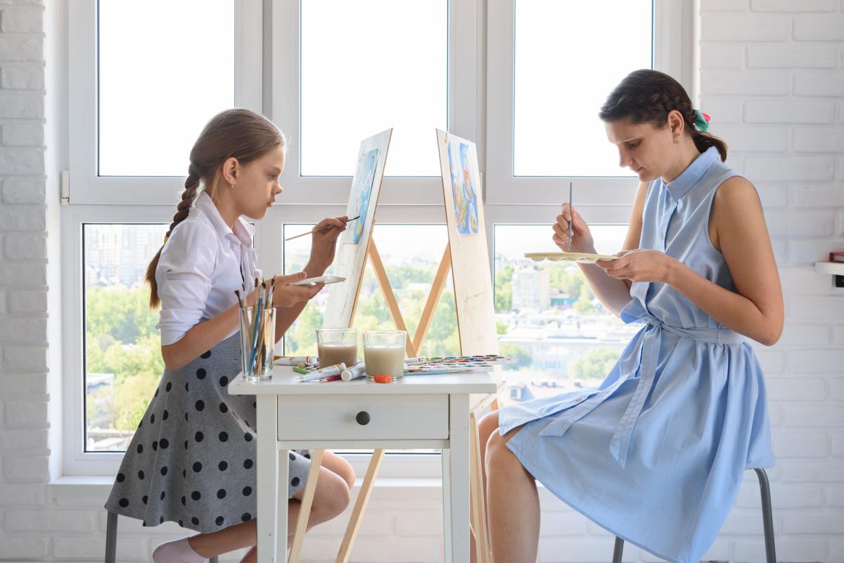 mother and child painting at easels across from each other